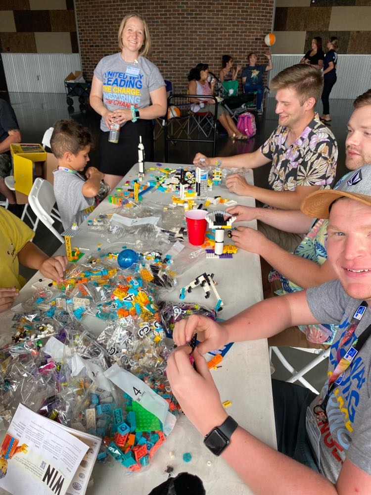 Adults building with legos